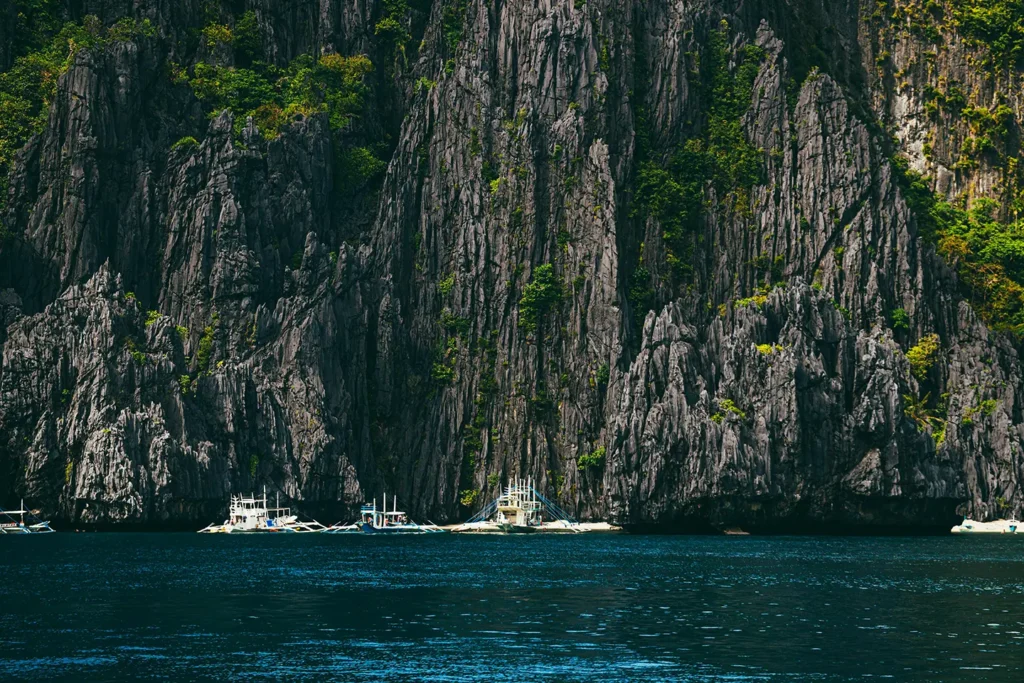 Towering, dramatic limestone cliffs in the clear waters of El Nido, Palawan.