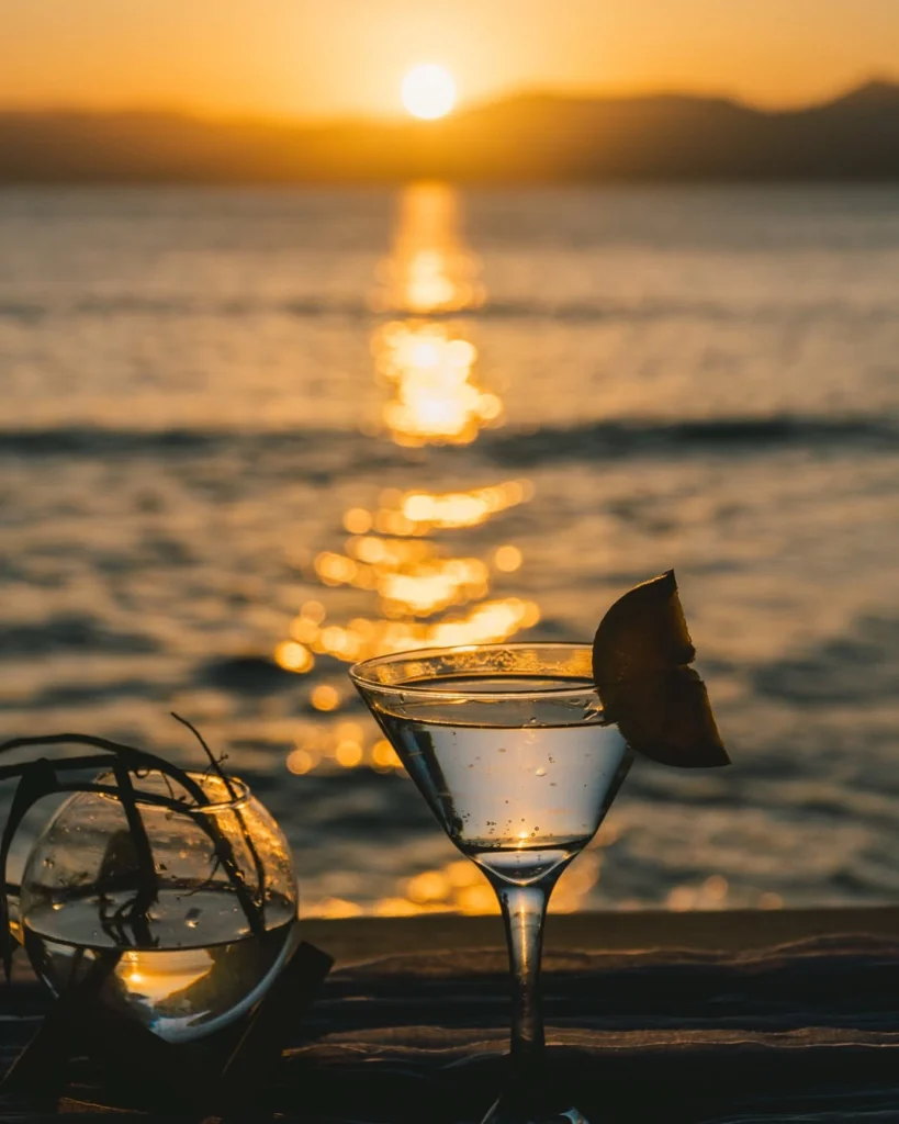 Cocktail glass at golden sunset over the sea at Parada Beach Camp Linapacan Palawan