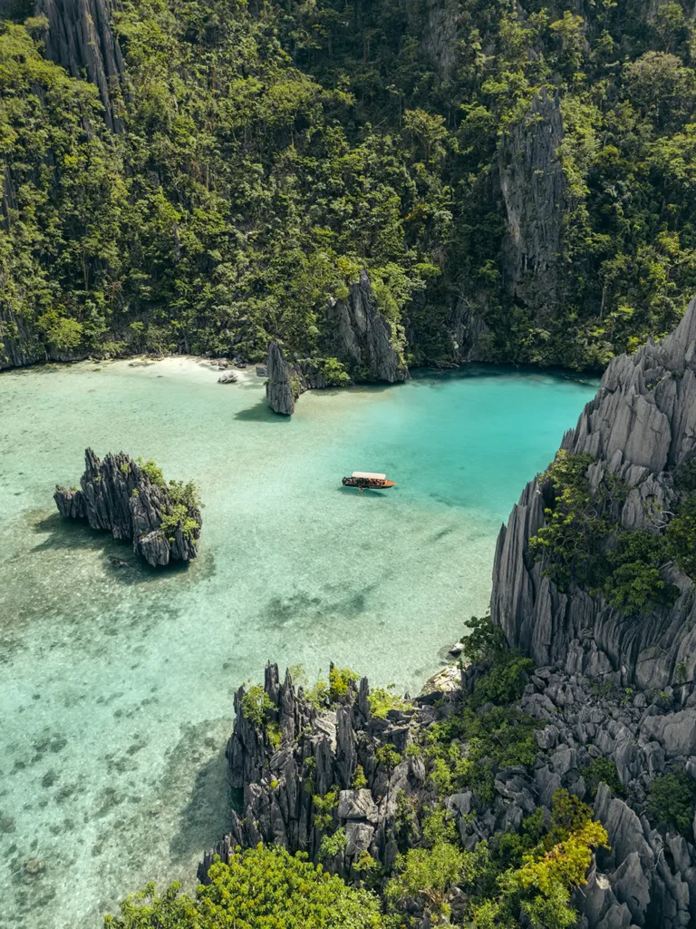 Aerial view of a Yohak speedboat anchored in shallow, crystal-clear tropical water